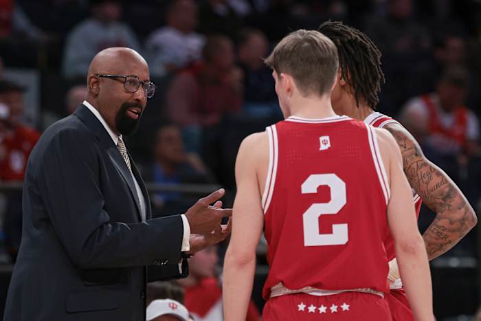Indiana Hoosiers head coach Mike Woodson talks with guard Gabe Cupps (2) and guard CJ Gunn (11) during the first half against the Louisville Cardinals at Madison Square Garden. 